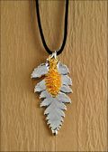 Double Small Silver Fern Necklace with Gold Pine Cone on Leather Cord